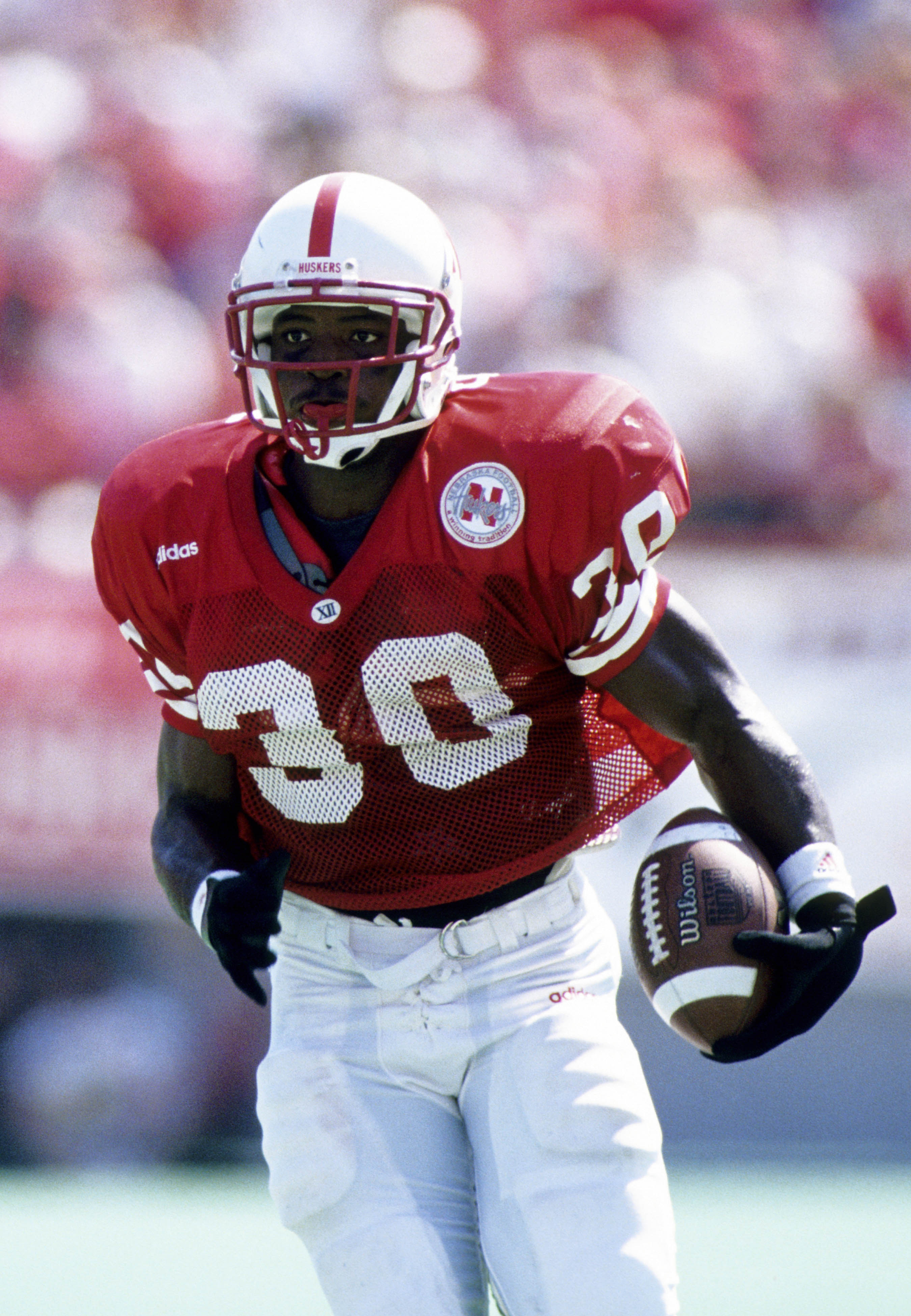 Ahman Green runs with the ball during college football game